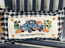 Load image into Gallery viewer, Decorative pillow with a blue truck and pumpkins design on a black and white checkered background.