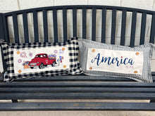 Load image into Gallery viewer, Two decorative pillows on a bench with one featuring a red truck and the other displaying 'America'.