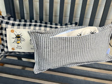 Load image into Gallery viewer, Striped pillow with bee design on a wooden surface