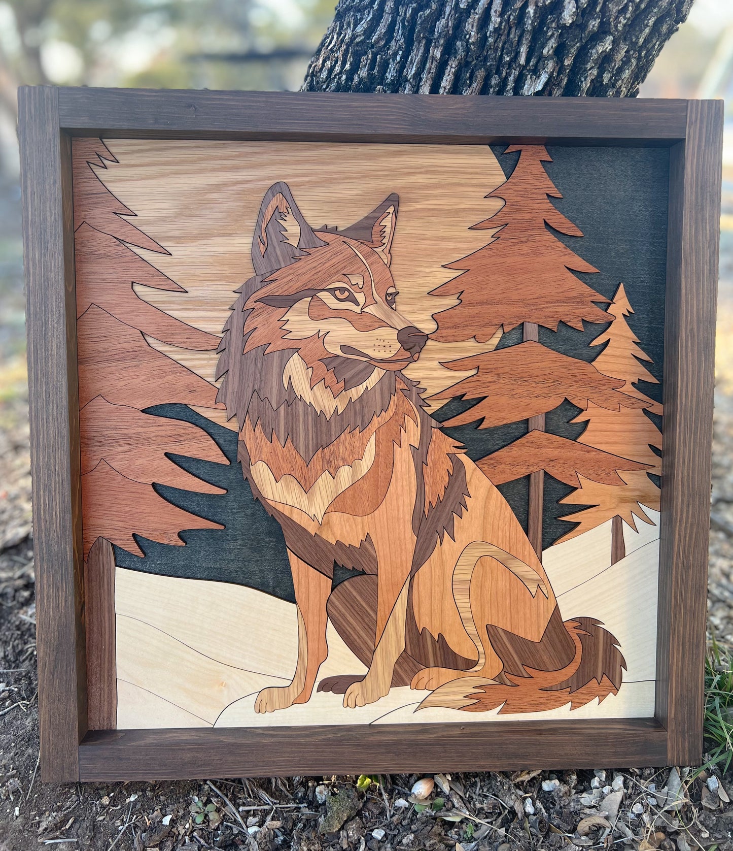 Laser-cut wooden artwork of a wolf in a forest setting, with a rustic farmhouse frame.