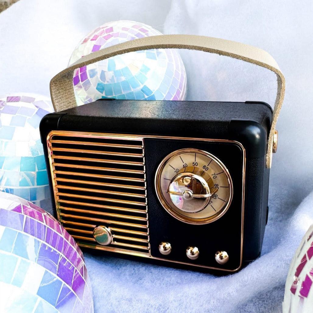 Vintage-style black radio with gold accents on a light blue background