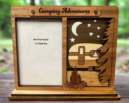 Wooden photo frame with camping design on a wooden surface