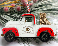 Load image into Gallery viewer, A vintage style red and white truck ornament with a dog riding in the back seat, placed on a branch with Christmas decorations.
