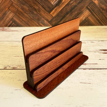 Load image into Gallery viewer, Playing card holder on a wooden surface with a wooden wall background