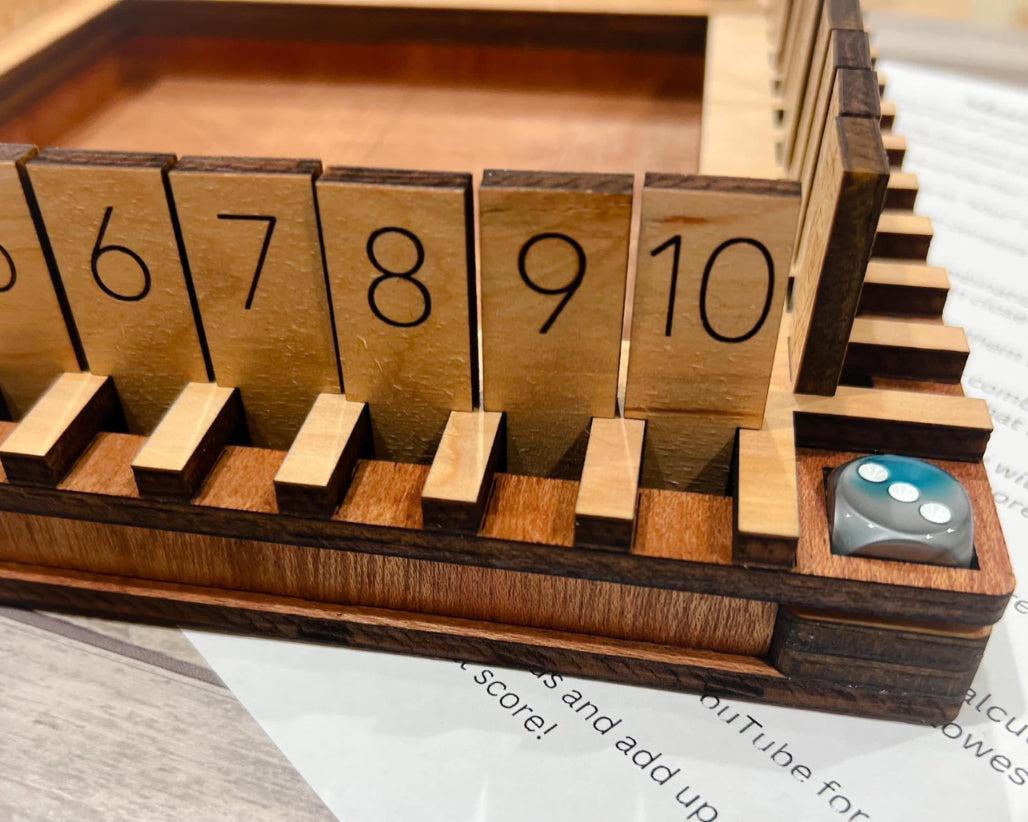 Close up of number tiles with dice in holder