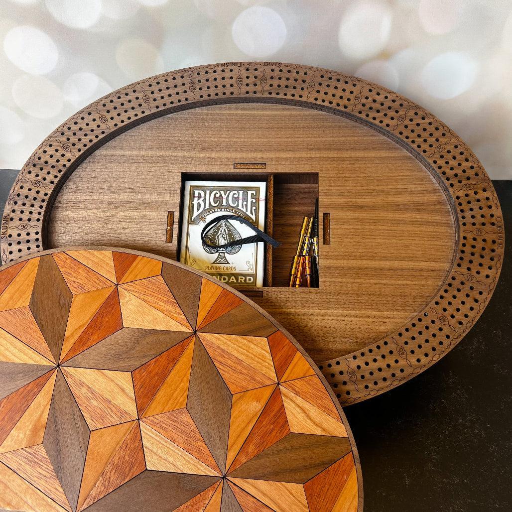 Wooden circular table with geometric pattern and Bicycle card box on a blurred background
