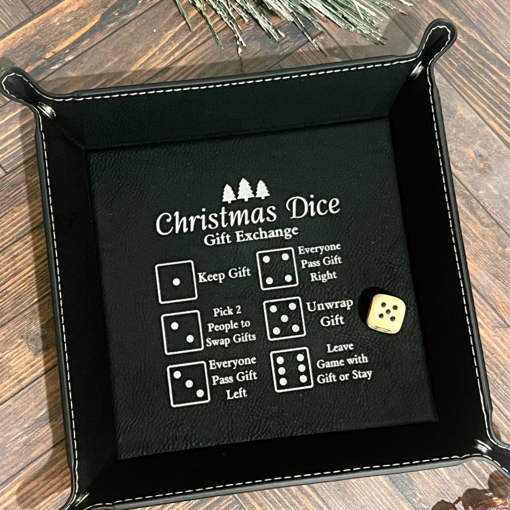 Green leather dice tray with engraved Christmas Dice Gift Exchange rules and a single die inside.