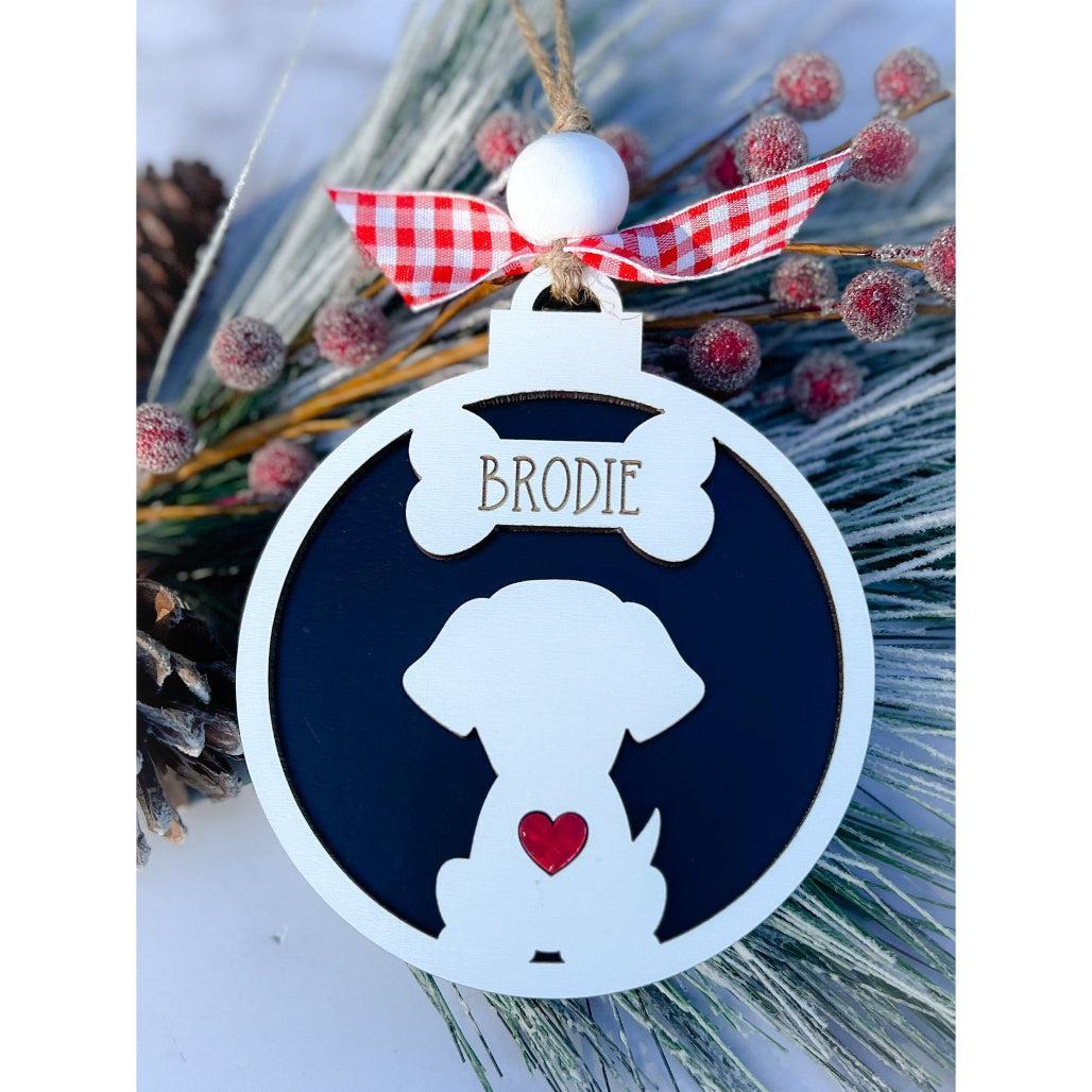 A personalized dog silhouette ornament with a white and black color scheme, adorned with a red and white checkered ribbon and a small red heart.