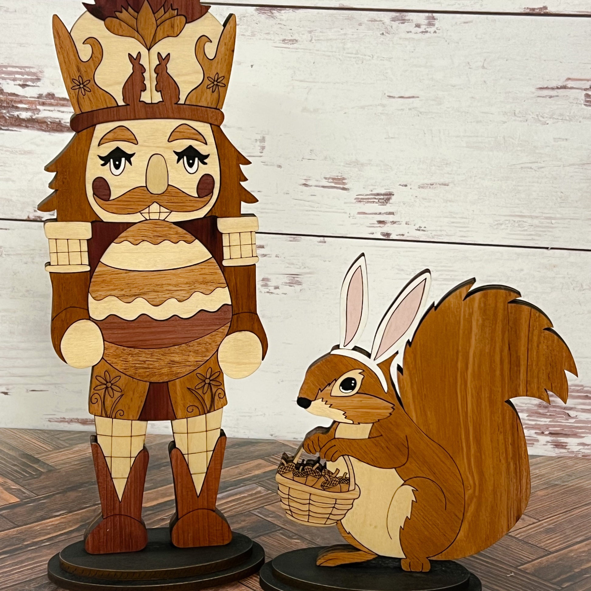 Wooden Easter décor set featuring a nutcracker with acorn crown and a squirrel with bunny ears holding a basket, displayed on a rustic wood surface.