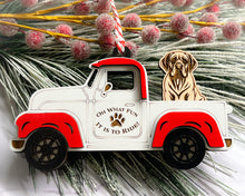 Load image into Gallery viewer, A vintage style red and white truck ornament with a dog riding in the back seat, placed on a branch with Christmas decorations.