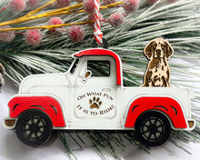 Load image into Gallery viewer, A vintage style red and white truck ornament with a dog riding in the back seat, placed on a branch with Christmas decorations.