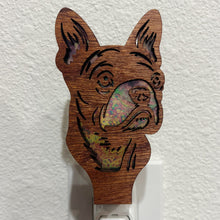 Load image into Gallery viewer, A laser-cut wooden night light in the shape of a dog&#39;s head, shown against a white wall.