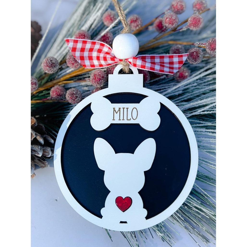 A personalized dog silhouette ornament with a white and black color scheme, adorned with a red and white checkered ribbon and a small red heart.