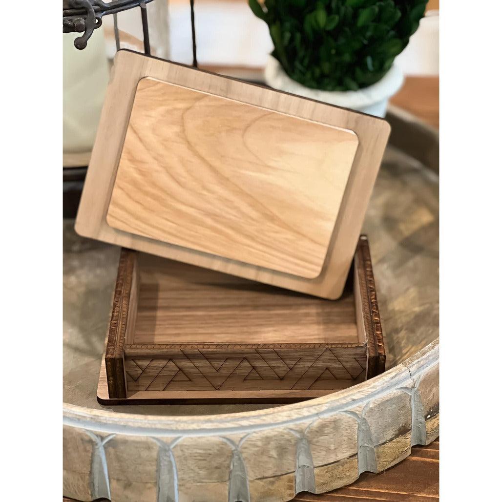 A wooden box with a geometric pattern on the lid that is open.