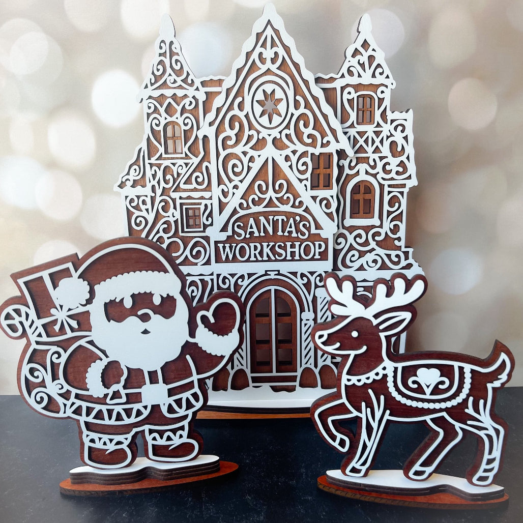 Decorative cutout of Santa's Workshop with Santa Claus and reindeer on a blurred background