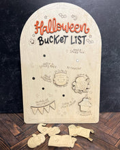 Load image into Gallery viewer, Wooden Halloween-themed board with cut-out pieces on a dark background