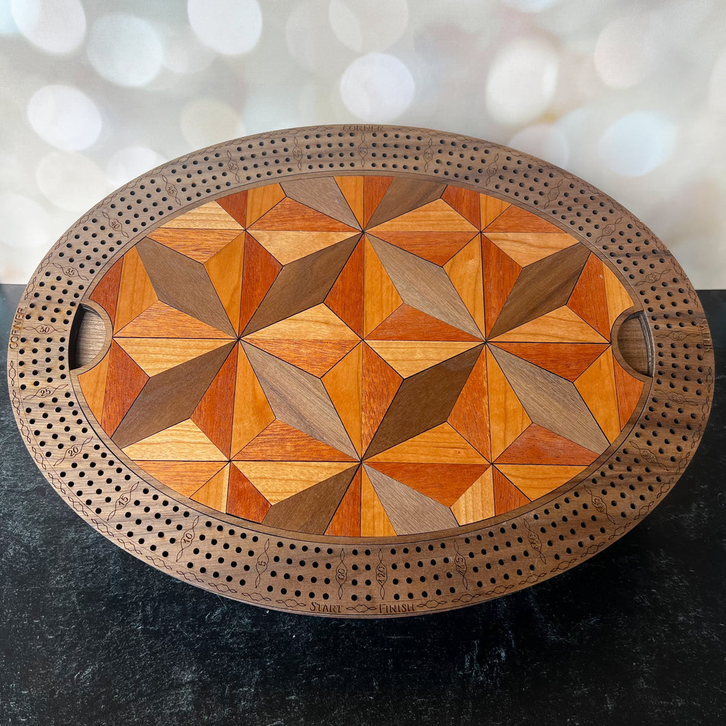 Wooden cribbage board with geometric pattern on a dark surface