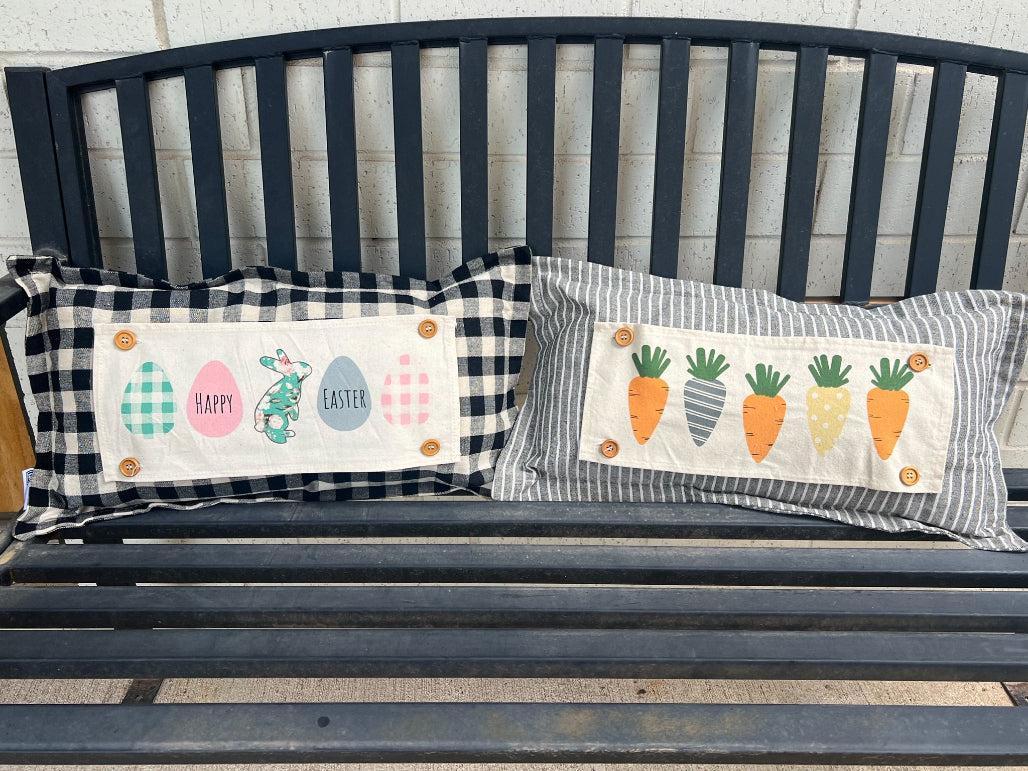 Two decorative pillows with Easter-themed designs on a wooden bench.