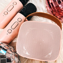 Load image into Gallery viewer, Two mini wireless karaoke speakers in pink and white colors with a Bluetooth remote control and two microphones.