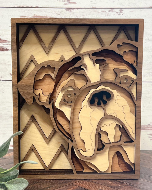 A handcrafted layered wood art piece depicting a bulldog with a geometric zigzag pattern in the background.