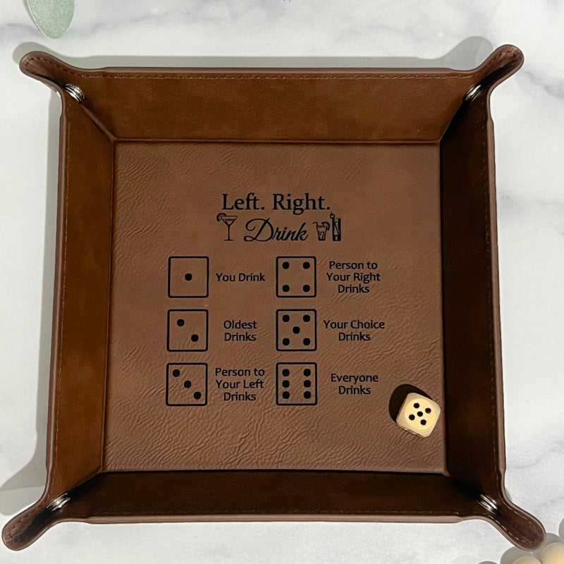 Brown leather dice tray with engraved Left Right Drink rules and a single die inside.