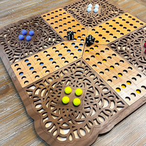 Wooden game board with dice and marbles on a wooden surface