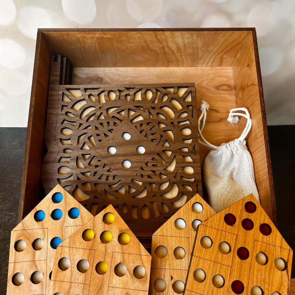 Wooden game set with intricate carvings and colorful pieces in a decorative box.