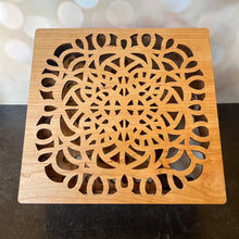 Load image into Gallery viewer, Wooden square coaster with intricate cut-out design on a dark surface.