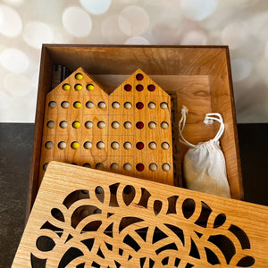 Wooden puzzle game set with pieces in a decorative box.