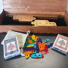 Load image into Gallery viewer, Colorful plastic pieces and Maverick playing cards on a wooden surface