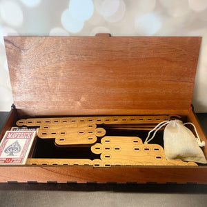 Wooden craps game set with dice cups and cards on a light background