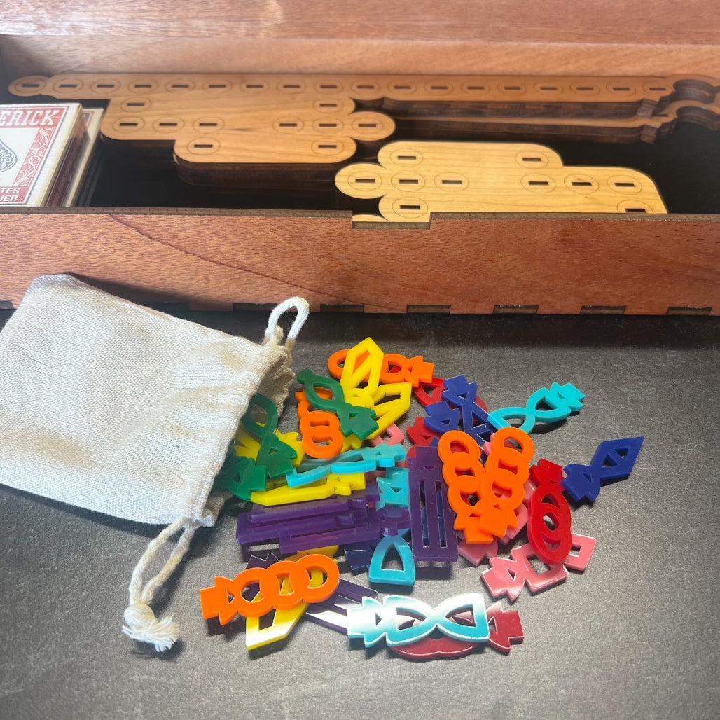 Colorful wooden puzzle pieces on a gray surface with a wooden box and bag in the background.