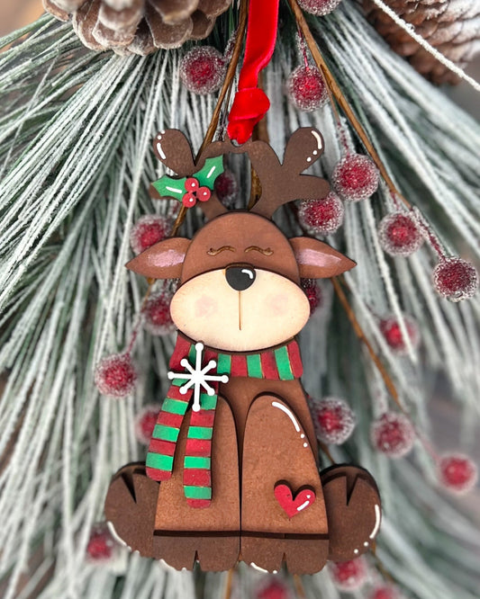 Christmas reindeer ornament with a scarf on a decorative background