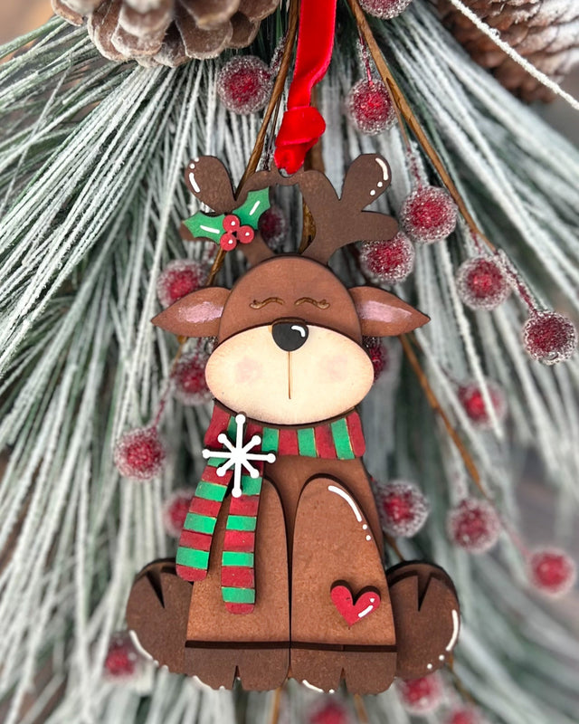 Christmas reindeer ornament with a scarf on a decorative background