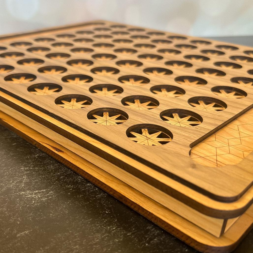 Wooden cutting board with geometric patterns on a dark surface