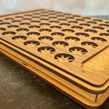 Load image into Gallery viewer, Wooden cutting board with geometric patterns on a dark surface