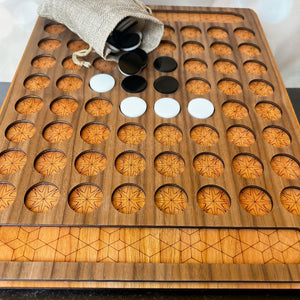 Wooden game board with circular compartments and game pieces on a marble surface