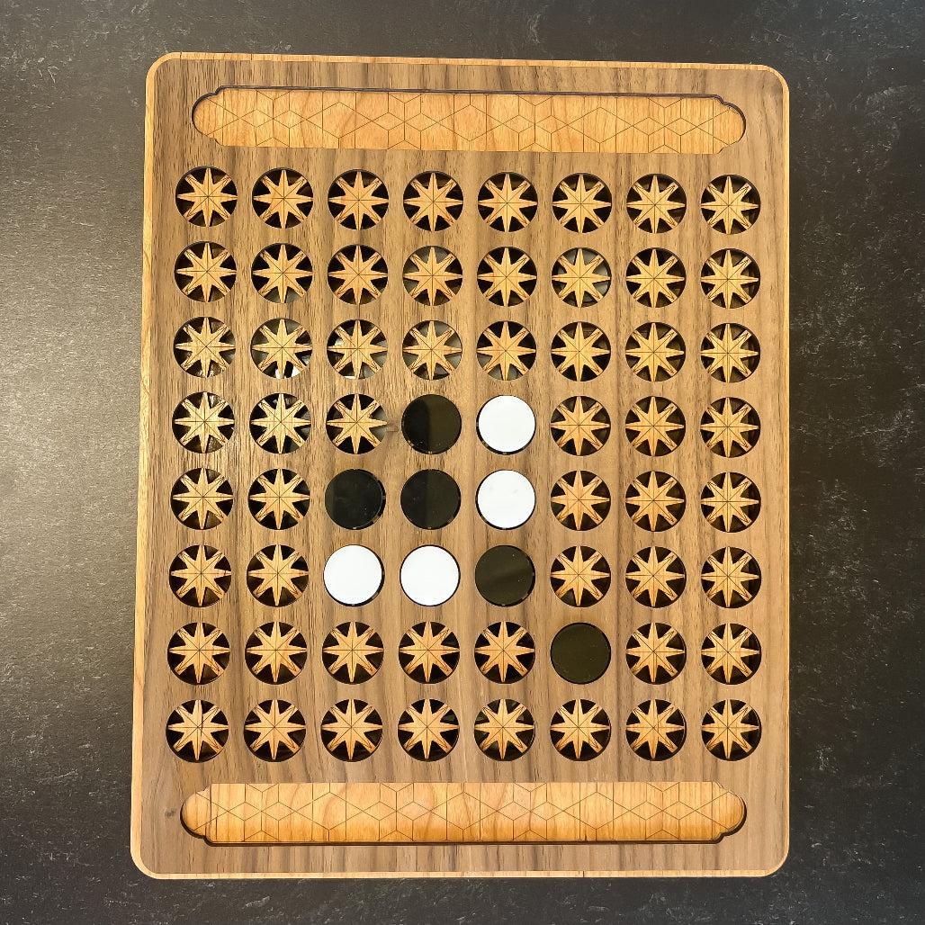 Wooden puzzle board with star patterns and circular cutouts on a dark surface
