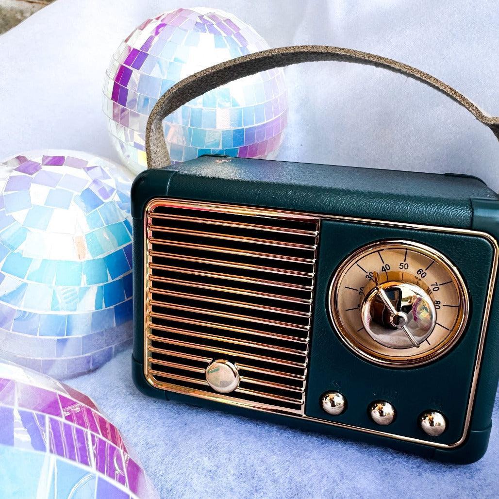 Vintage-style radio with disco balls on a light blue background