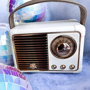 Vintage-style radio with disco balls on a blue background