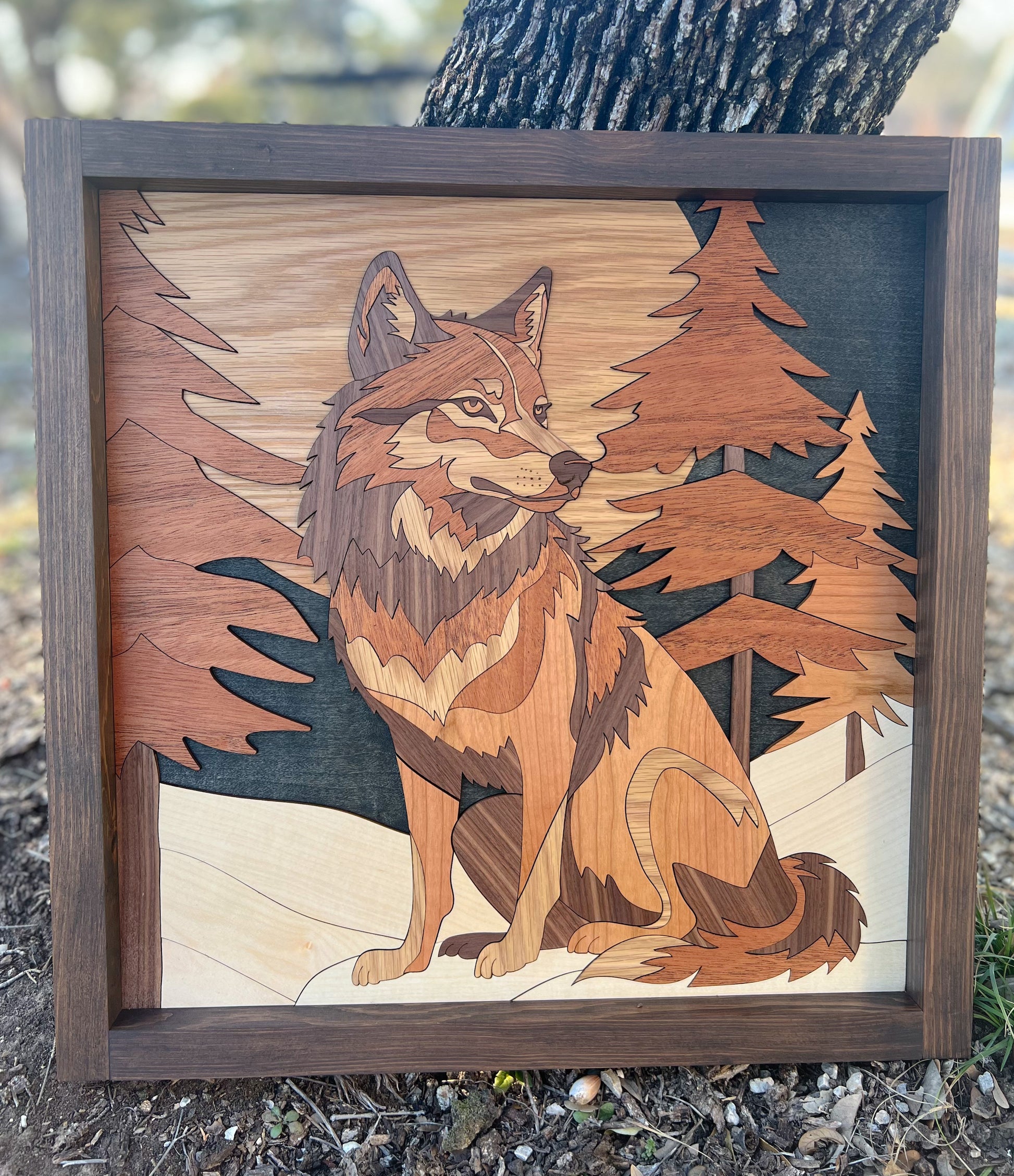 Laser-cut wooden artwork of a wolf in a forest setting, with a rustic farmhouse frame.