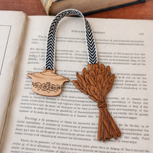 Load image into Gallery viewer, Wooden bookmark with decorative elements on an open book