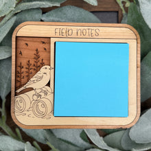 Load image into Gallery viewer, Wooden notebook cover with bird illustration and 'Field Notes' branding on a green leaf background