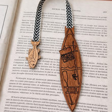 Load image into Gallery viewer, Wooden bookmark with decorative strap on an open book
