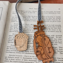 Load image into Gallery viewer, Wooden key and basket ornament on an open book