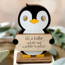 Load image into Gallery viewer, Wooden penguin figurine holding a sign with 'life is better when we waddle together' text.