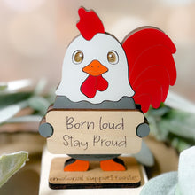 Load image into Gallery viewer, Decorative rooster figurine with 'Born loud Stay Proud' message on a blurred natural background