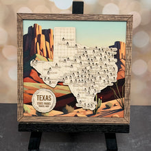Load image into Gallery viewer, Wooden map of Texas with scenic illustrations on a stand against a desert background