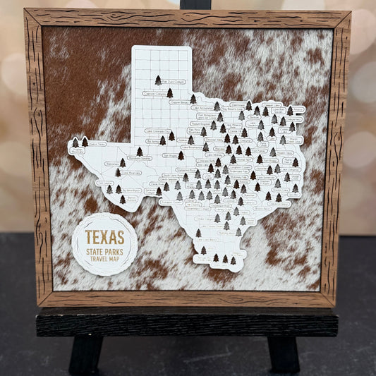 Map of Texas state parks on a wooden frame with a cowhide texture background
