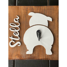 Load image into Gallery viewer, Wooden dog leash holder with white bulldog silhouette, personalized name “Stella,” and black metal hook on rustic wood background.